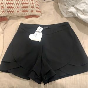 Paper heart fancy, ruffle black shorts with pockets. Never worn, tags on!